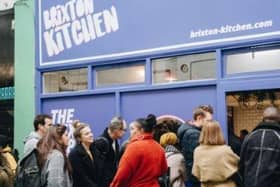 People gathered around the Brixton Kitchen market
