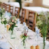 Wedding venue table setting with flowers.