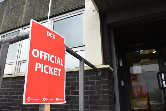 Members of the PCS union formed a picket line outside Wigan Jobcentre