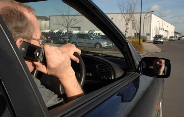 PICTURE POSED BY MODEL. File photo dated 14/02/2007 of a driver talking on his mobile telephone while driving. Sightings of handheld mobile phone use by drivers are common on UK roads despite Friday being the 20th anniversary of the practice being banned, a survey suggests. Some 93% of respondents to a poll of more than 12,000 AA members said they often see other motorists using a phone at the wheel. Issue date: Friday December 1, 2023.
