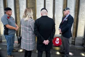 The group pay their respects at the London King's Cross War Memorial