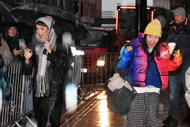 Dancers Lauren Oakley and Nancy Xu arrive in the heavy rain.