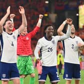 Declan Rice, Kobbie Mainoo and Luke Shaw celebrate after England beat the Netherlands during the UEFA EURO 2024 semi-final match.