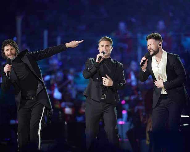 Howard Donald and Gary Barlow of Take That, perform with Callum Scott (right) on stage during the Coronation Concert