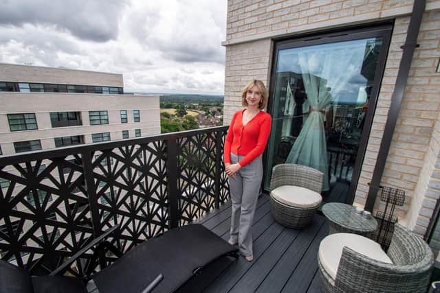 Alina on the balcony of her apartment