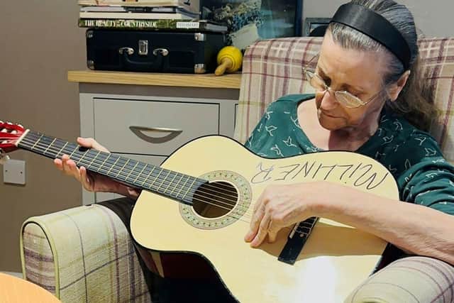Samantha playing the guitar