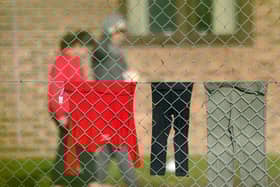 A view of people thought to be migrants at the Manston immigration short-term holding facility located at the former Defence Fire Training and Development Centre in Thanet, Kent. 700 people were moved to the Manston facility for safety reasons after incendiary devices were thrown at a Border Force migrant centre in Dover on Sunday. Picture date: Monday October 31, 2022.