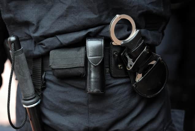 The Metropollitan police prepare to carry out a raid on a property on the Churchill Gardens estate in Pimlico during Operation Woodstock, London