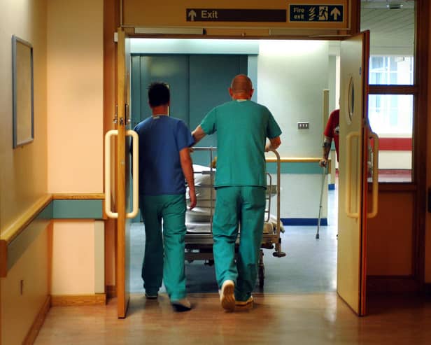 Orderlies push a bed at the Royal Orthopaedic Hospital, Oswestry.