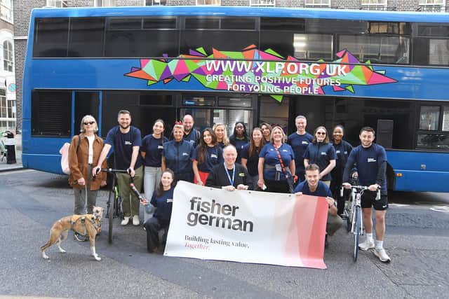 Tim Sledge, Director of Fundraising at XLP (front, centre), joins the Fisher German team with one of the charity’s mobile youth centres as they set off on their Big 25 fundraising challenge, giving them an insight into what the funds raised will be used for.