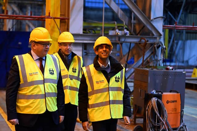CEO John Wood, Secretary of State for Northern Ireland, Chris Heaton-Harris and Prime Minister Rishi Sunak during a visit to Harland & Wolff shipyard factory in Belfast. Picture date: Friday December 16, 2022. Credit: Charles McQuillan