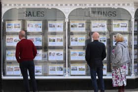 People looking at house price signs displayed in the window of an estate agents in Lewes, East Sussex, as the Office for National Statistics (ONS) has said that the average UK house price has surged by £24,000 during the past year of coronavirus lockdowns. Issue date: Wednesday May 19, 2021.