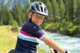 11 year old Aleksandr raises money by cycling through the Swiss mountains.