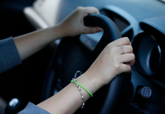**PICTURE POSED BY MODEL**
A woman driving.