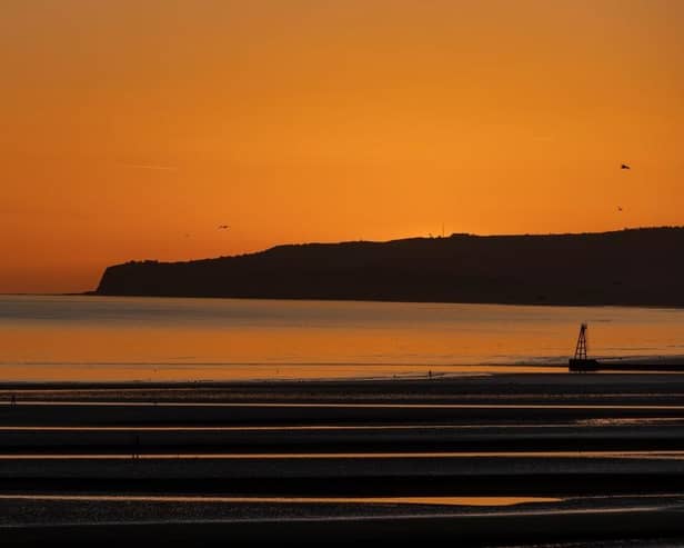 The sun sets over Camber Sands.