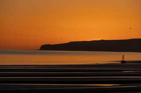 The sun sets over Camber Sands.