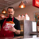 See Danny in a chippy apron greeting fans with free portions of Frank's fish and chips.jpg