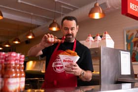 See Danny in a chippy apron greeting fans with free portions of Frank's fish and chips.jpg