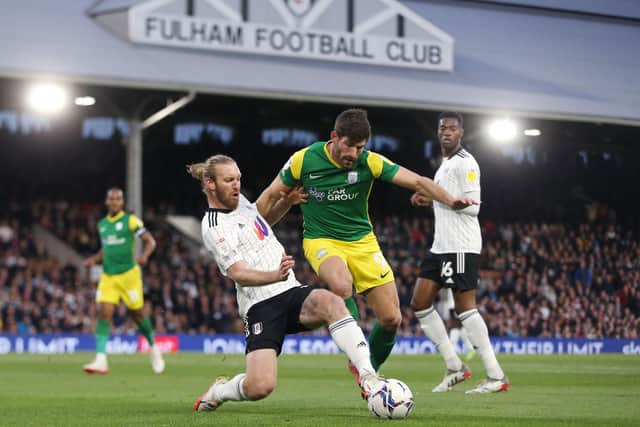 Preston North End striker Ched Evans is challenged by Fulham skipper Tim Ream at Craven Cottage