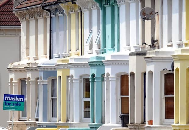 Embargoed to 0001 Monday December 20 File photo dated 06/08/2009 of a for sale sign outside houses in Brighton. The number of homes in England that are empty has fallen for the first time in three years, research showed today.