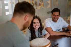 A team smiling as they anticipate enjoying an entry into Best Office Baker.