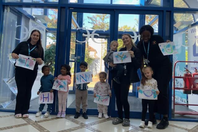 Monkey Puzzle Chadwell Heath children and staff holding up thank you sign.