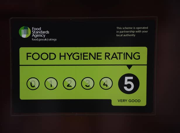 <p>A Food Standards Agency rating sticker on a window of a restaurant in central London. A huge variation in food hygiene standards remains across the UK, with one in five high or medium-risk food outlets failing to meet standards, according to a study.</p>