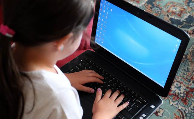 File photo dated 21/08/14 of a child using a laptop computer. Research, by Dr Killian Mullan at Oxford University concludes that youngsters are combining new technology with every day life.