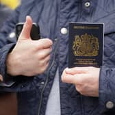 Alex Sladen holding his new passport in front of members of the PCS union on the picket line outside the Passport Office in east London, as more than 1,000 members of the Public and Commercial Services (PCS) union working in passport offices in England, Scotland and Wales begin a five week strike as part of the civil service dispute. Picture date: Monday April 3, 2023.