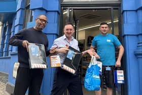 The Leyland team hand over the materials.