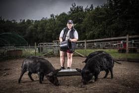 Millie Boon with three of the farm's pigs - Image Pete Muller/ Animal News Agency.