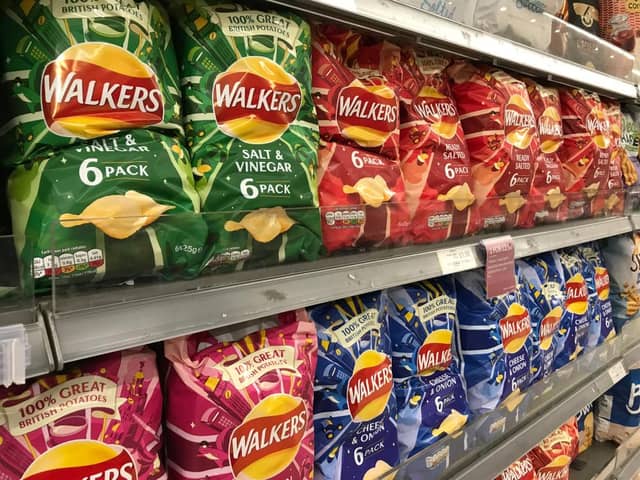 Packets of Walkers crisps on shelves in a supermarket (Shutterstock)