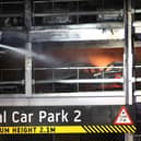 Firefighters battle the fire at Luton Airport which caused a partial collapse of a parking structure in Luton on October 11, 2023. . Photo by HENRY NICHOLLS/AFP via Getty Images
