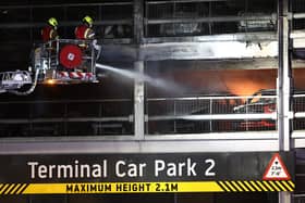 Firefighters battle the fire at Luton Airport which caused a partial collapse of a parking structure in Luton on October 11, 2023. . Photo by HENRY NICHOLLS/AFP via Getty Images