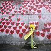File photo dated 23/3/2022 of flowers by the The National Covid Memorial Wall in London. Bereaved families have warned they may take legal action against the Government over delays to starting the coronavirus public inquiry. The Covid-19 Bereaved Families for Justice group is considering bringing a judicial review over the failure to provide a setting up date for the inquiry into the Government's handling of the pandemic. Issue date: Monday June 27, 2022.