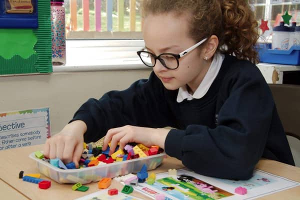 Young child enjoys playing with LEGO® bricks
