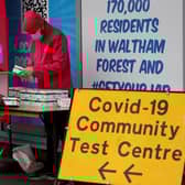 People arrange boxes at a free Covid-19 rapid lateral flow test kit handout point on Hoe Street in Walthamstow, north London on December 30, 2021. Photo by TOLGA AKMEN/AFP via Getty Images