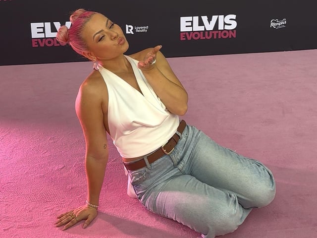 Molly Lanaghan blows a kiss to the camera as she poses on the pink carpet