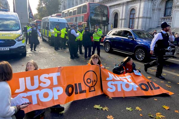 Members of Just Stop Oil block off the road in Whitehall.