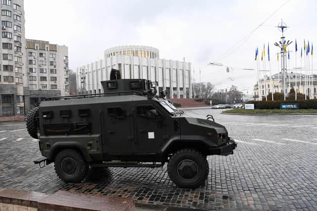 A Ukrainian military vehicle drives in central Kyiv on February 24, 2022. Air raid sirens rang out in downtown Kyiv today as cities across Ukraine were hit with what Ukrainian officials said were Russian missile strikes and artillery. Photo: Daniel LEAL / AFP.